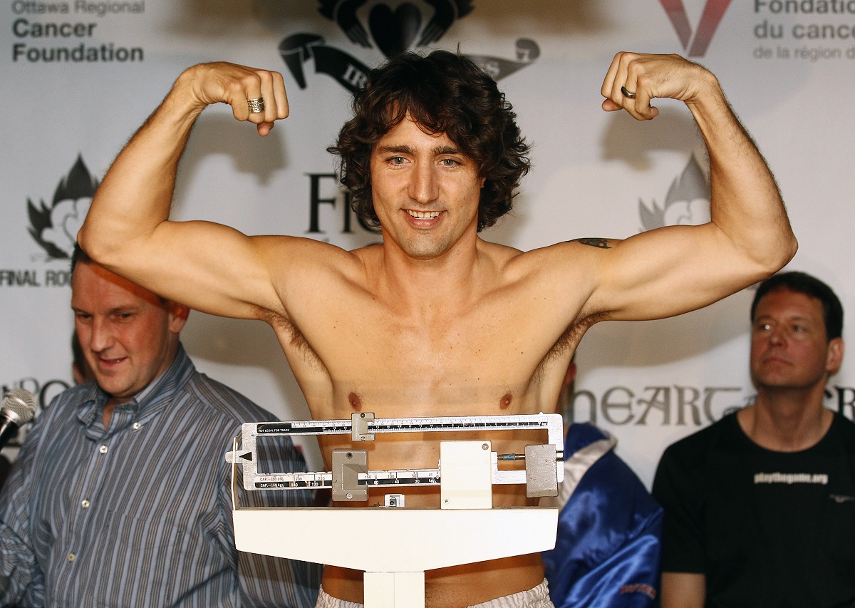 Liberal MP Trudeau gestures while weighing-in for a charity boxing match in Ottawa