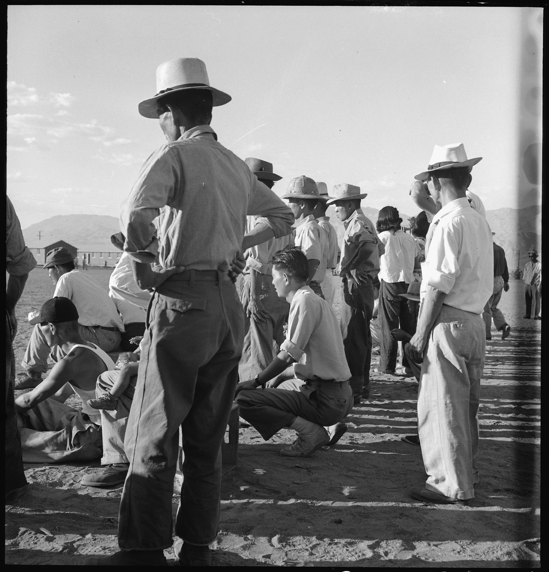 dorothea_lang_Manzanar_Relocation_Center,_Manzanar,_California._Evacuees_of_Japanese_ancestry_are_enjoying_a_base_._._._-_NARA_-_538067